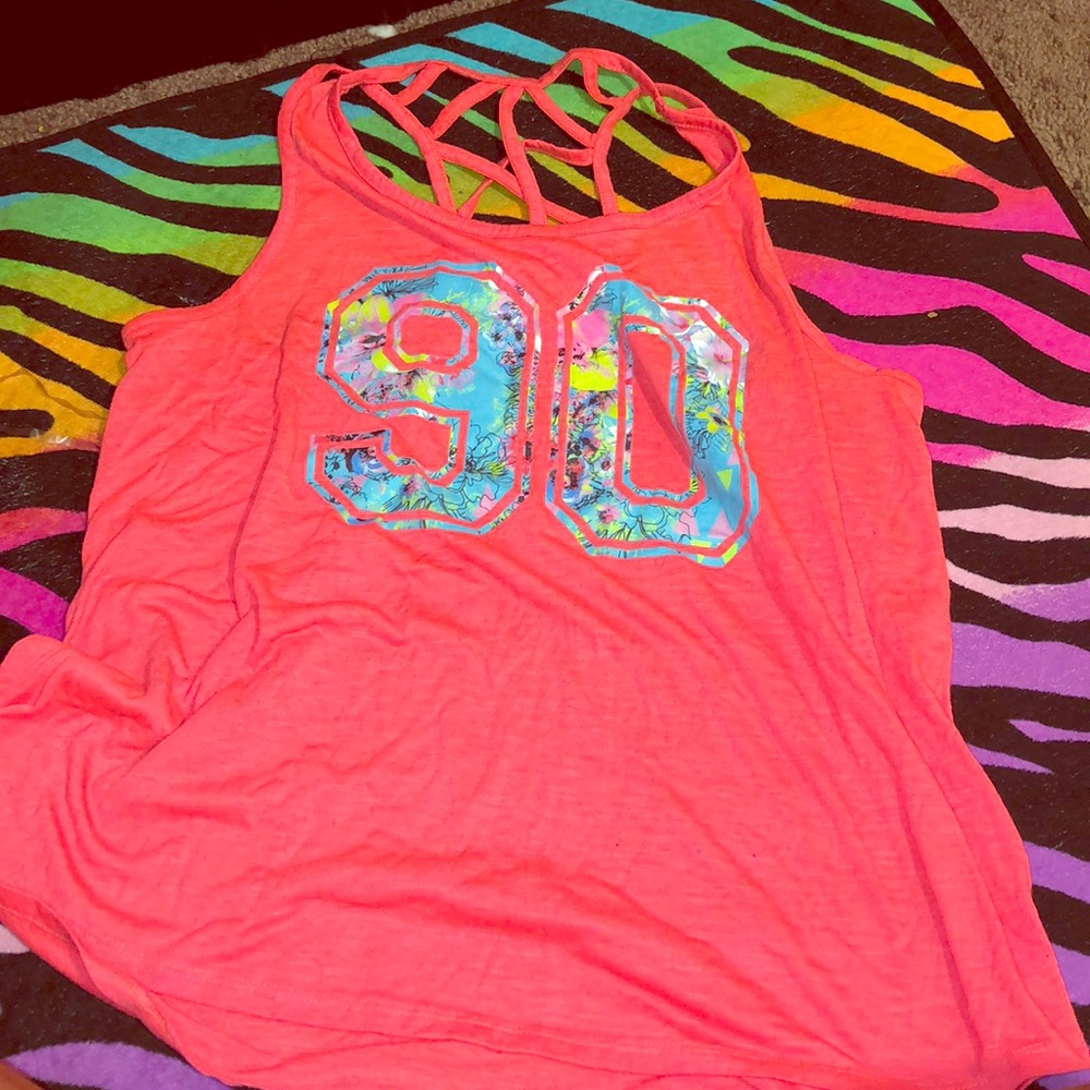 A shirt that’s has a 90 on with floral pattern